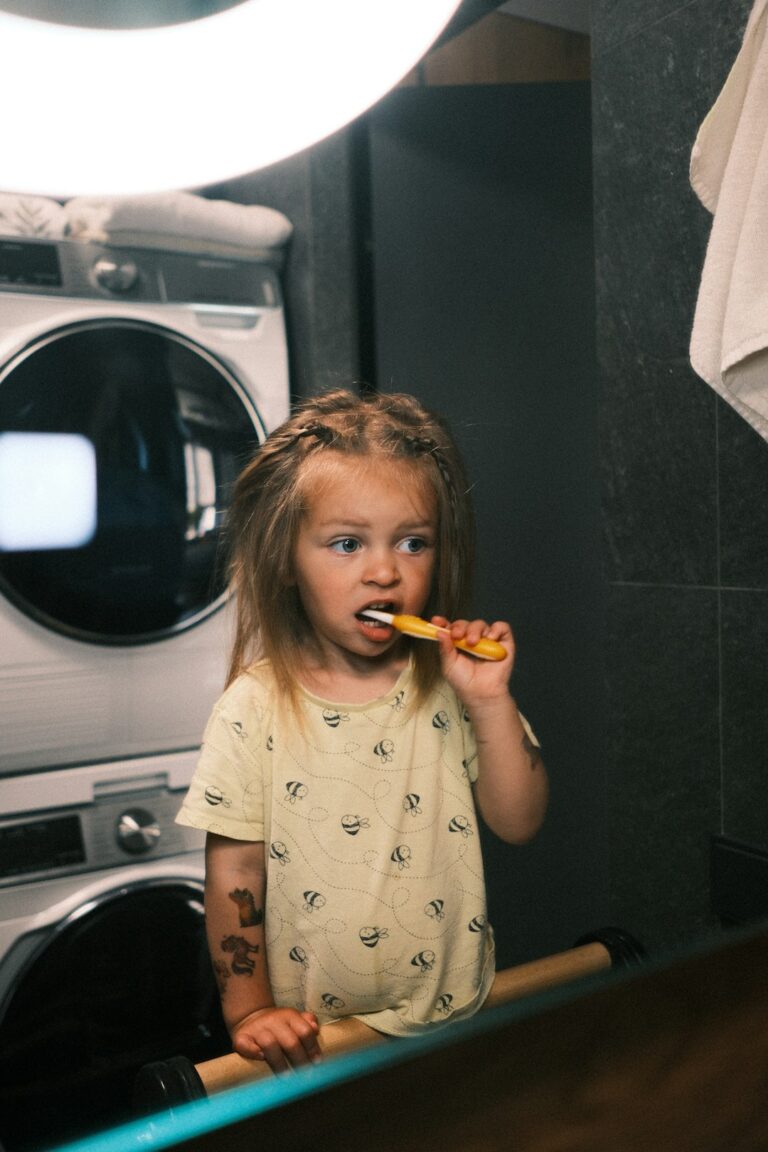 A young patient wearing a protective apron receiving a dental X-ray in a dentist's office.